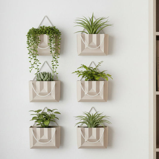Beige gift bag planter with a rope handle on a light gray background