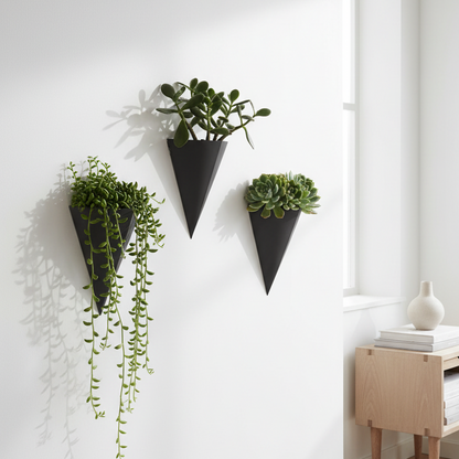 Three wall-mounted planters with green plants in a minimalistic room.