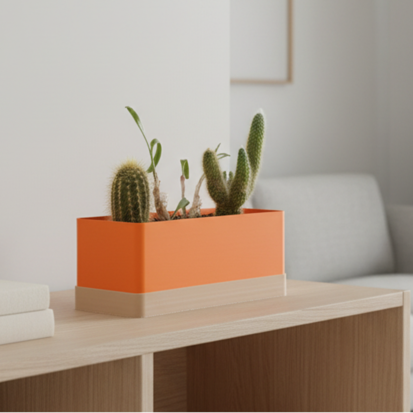 Modern orang planter with a wooden tray, on a shelf, gray sofa, and decorative items.